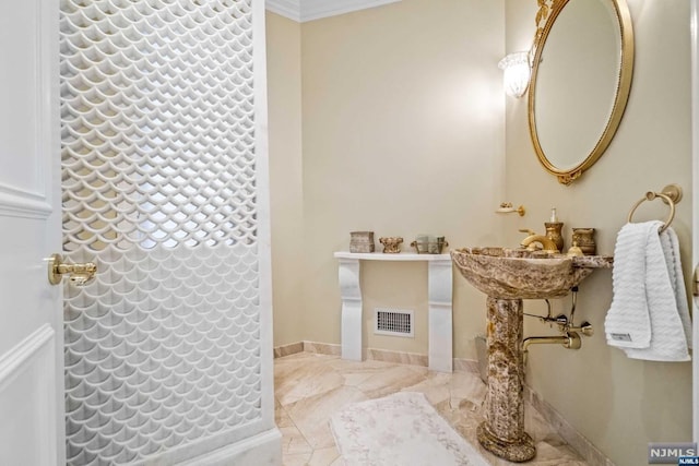 bathroom featuring tile patterned floors, sink, and ornamental molding