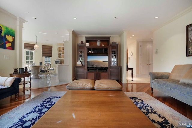 living room featuring ornamental molding and hardwood / wood-style flooring