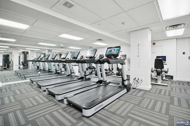 workout area featuring carpet flooring and a drop ceiling