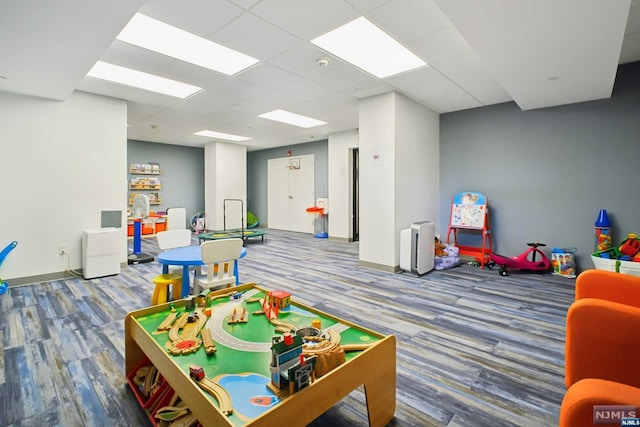 recreation room with hardwood / wood-style floors and a drop ceiling