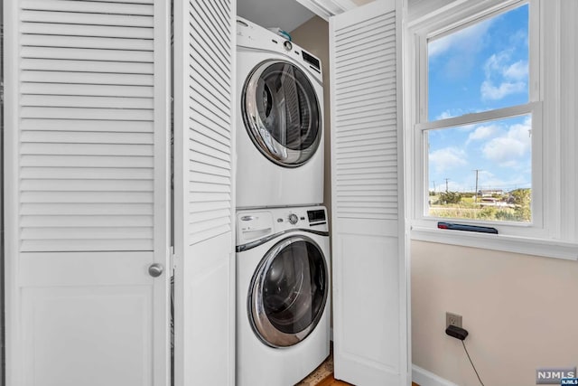 washroom with stacked washer and clothes dryer