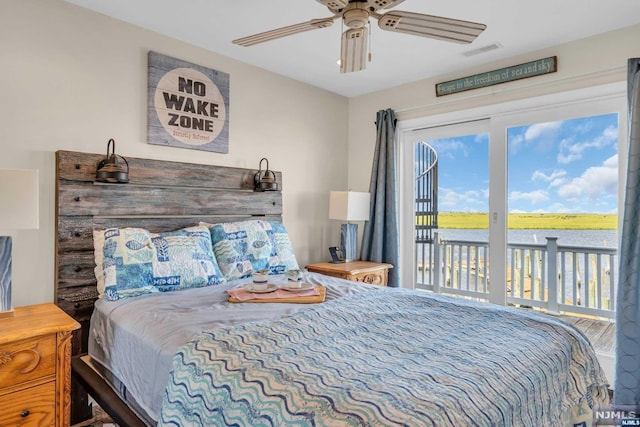 bedroom featuring ceiling fan, access to exterior, and a water view