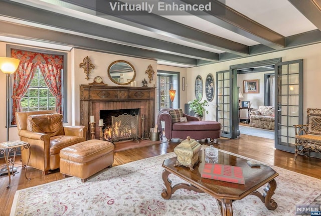 living room featuring a fireplace, french doors, beam ceiling, and wood-type flooring