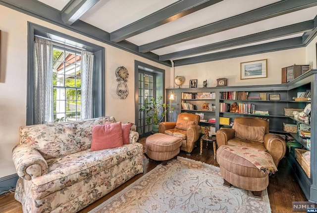 living area featuring beam ceiling and hardwood / wood-style flooring