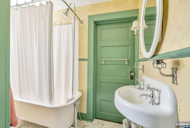 bathroom with shower / tub combo and sink