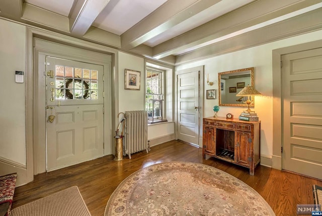 entryway with beamed ceiling, dark hardwood / wood-style flooring, and radiator heating unit