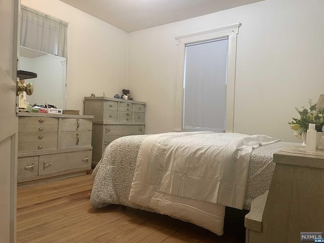 bedroom with light wood-type flooring