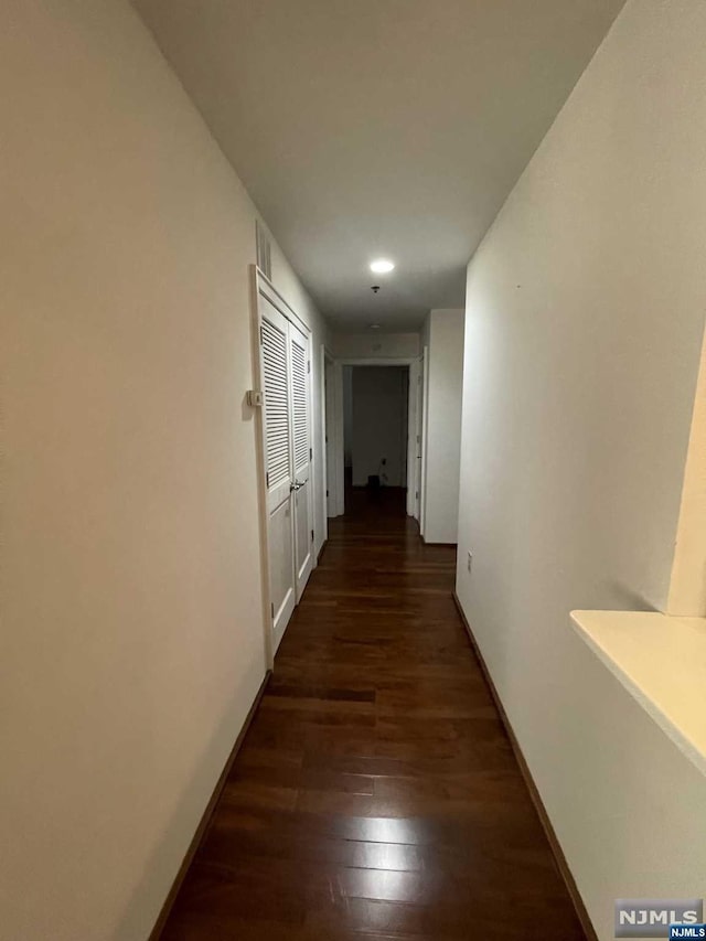 hallway featuring dark wood-type flooring