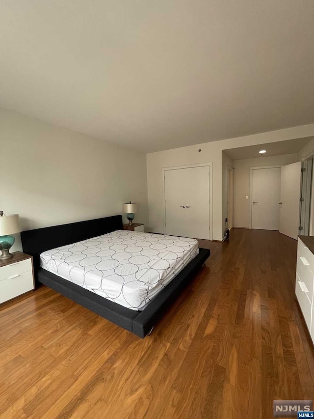 unfurnished bedroom featuring hardwood / wood-style flooring