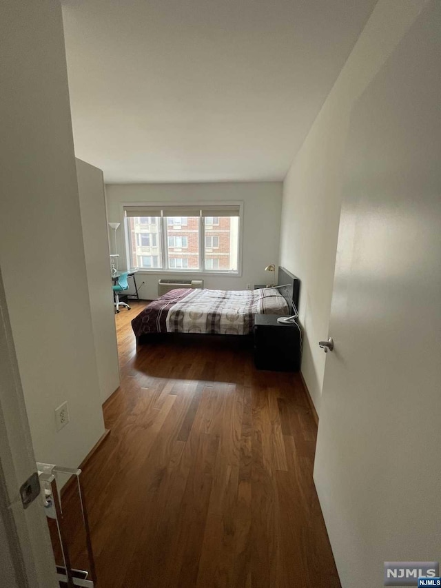 bedroom featuring dark wood-type flooring