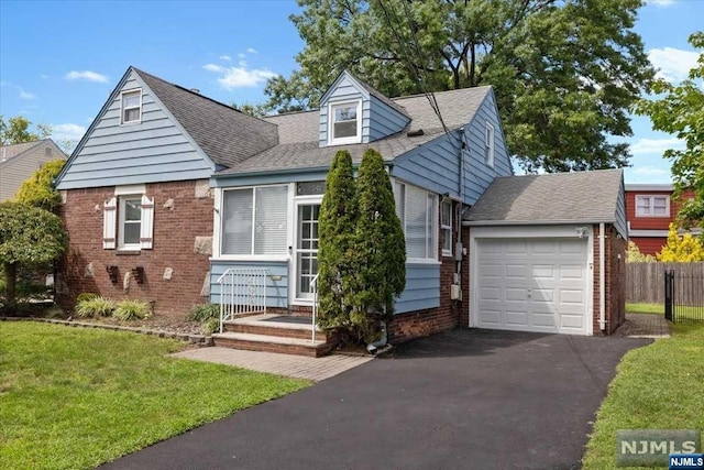 view of front of house with a front lawn and a garage