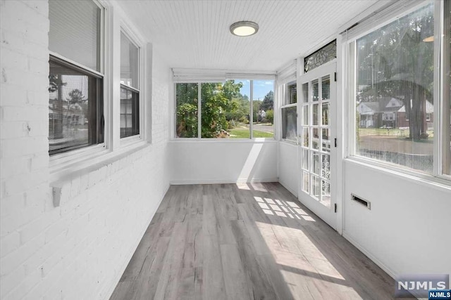 unfurnished sunroom featuring a healthy amount of sunlight