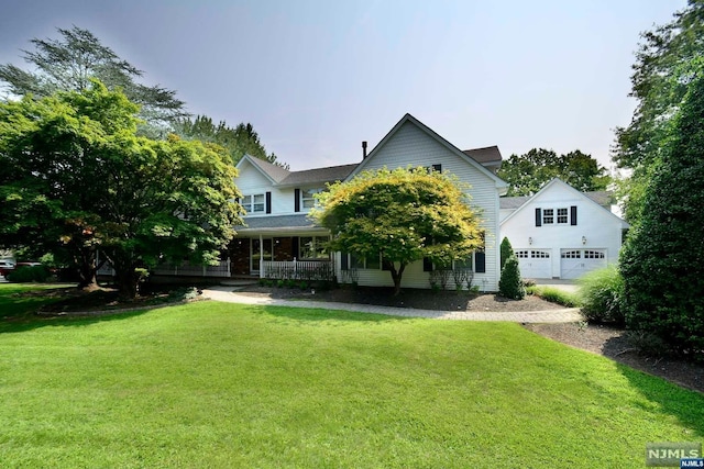 view of front of home featuring a front lawn, a porch, and a garage