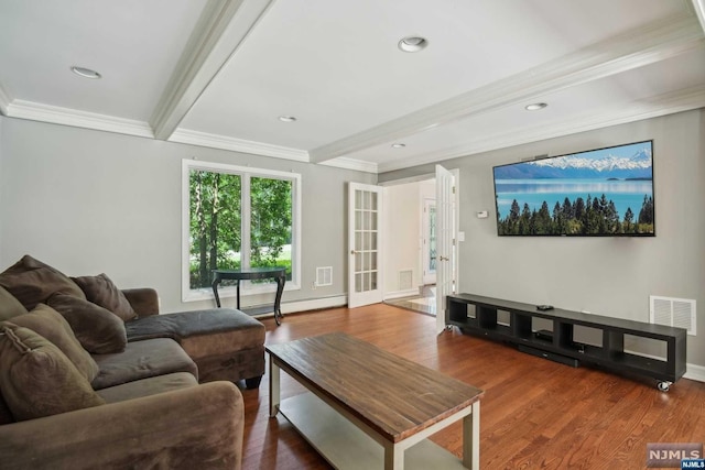 living room featuring french doors, baseboard heating, beamed ceiling, wood-type flooring, and ornamental molding