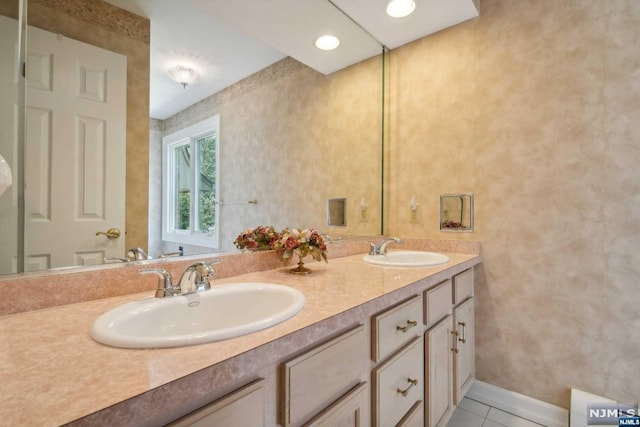 bathroom featuring tile patterned flooring and vanity