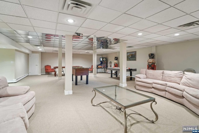 living room featuring light carpet, a drop ceiling, and a baseboard heating unit