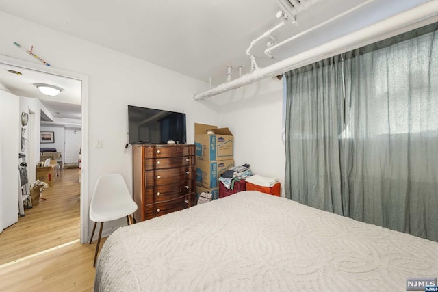 bedroom with hardwood / wood-style floors