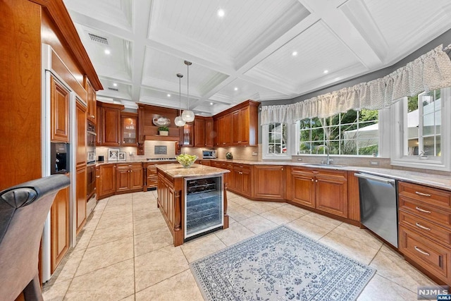 kitchen with sink, a center island, beverage cooler, coffered ceiling, and appliances with stainless steel finishes