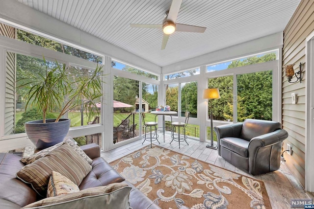 sunroom / solarium with plenty of natural light and ceiling fan