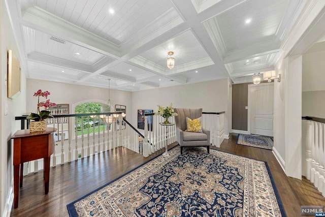 sitting room with beamed ceiling, dark wood-type flooring, and coffered ceiling