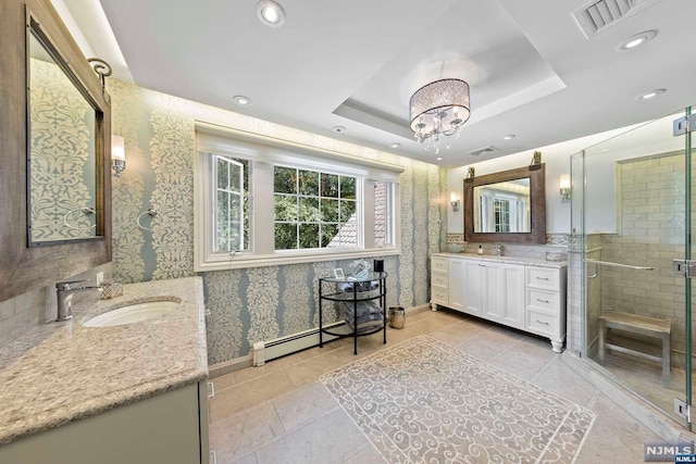 bathroom with vanity, a baseboard heating unit, a tray ceiling, a notable chandelier, and an enclosed shower