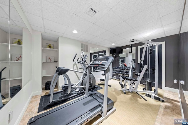 workout area featuring a paneled ceiling