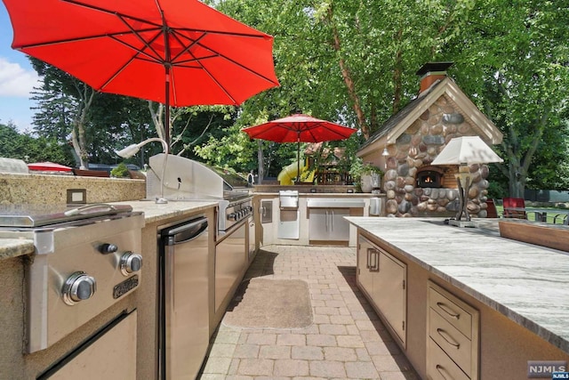 view of patio / terrace with grilling area and an outdoor kitchen