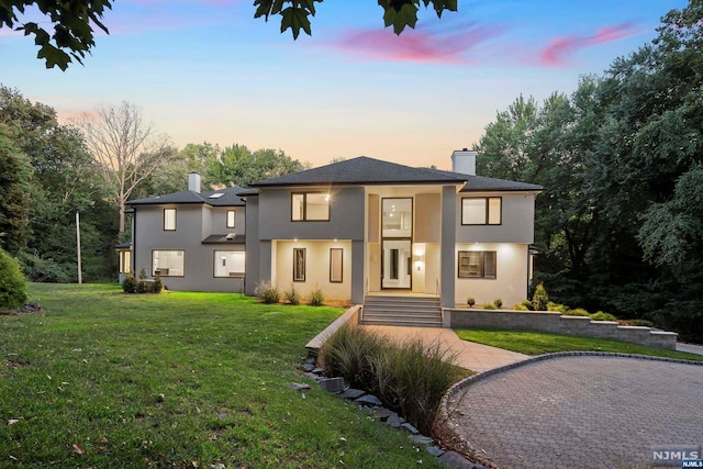 view of front of home with a lawn