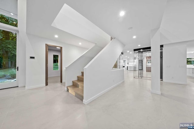 staircase featuring concrete flooring