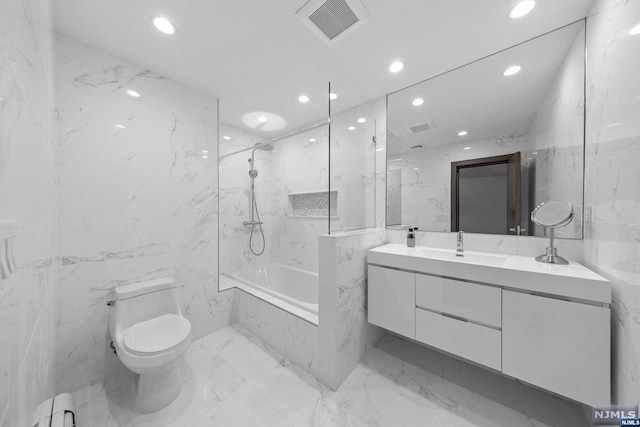 full bathroom with vanity, tiled shower / bath combo, a baseboard radiator, tile walls, and toilet