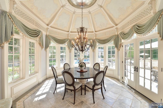 sunroom with a notable chandelier, plenty of natural light, and french doors