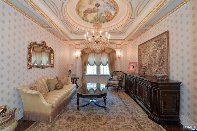 sitting room with a chandelier, a tray ceiling, and crown molding