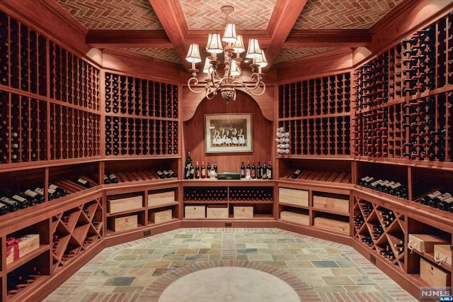 wine room featuring an inviting chandelier and brick ceiling