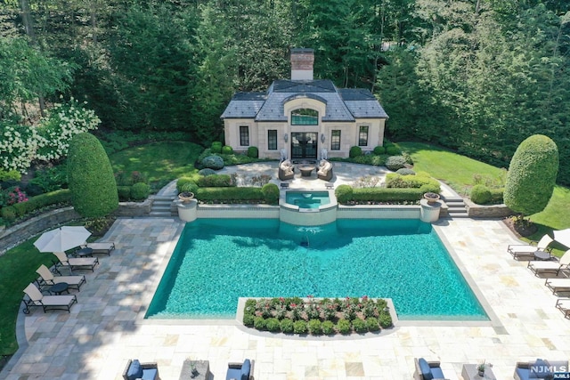 view of swimming pool with a patio area and an outbuilding