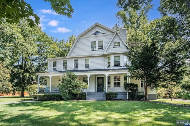 view of front of home with a front lawn and a porch