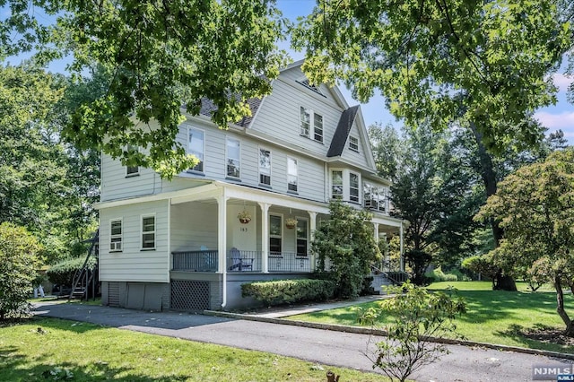 view of property featuring a front yard and a porch