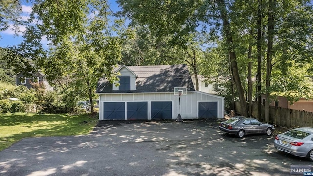 view of front of property with a garage and a front lawn