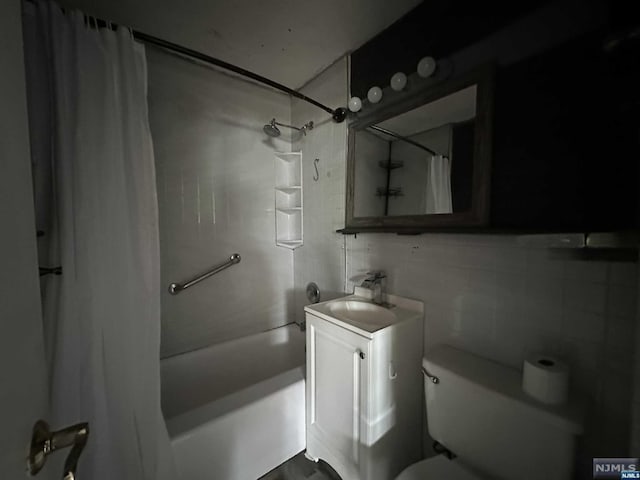 full bathroom with vanity, shower / bath combination with curtain, tile walls, and toilet