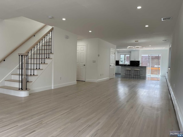 unfurnished living room with light wood-type flooring