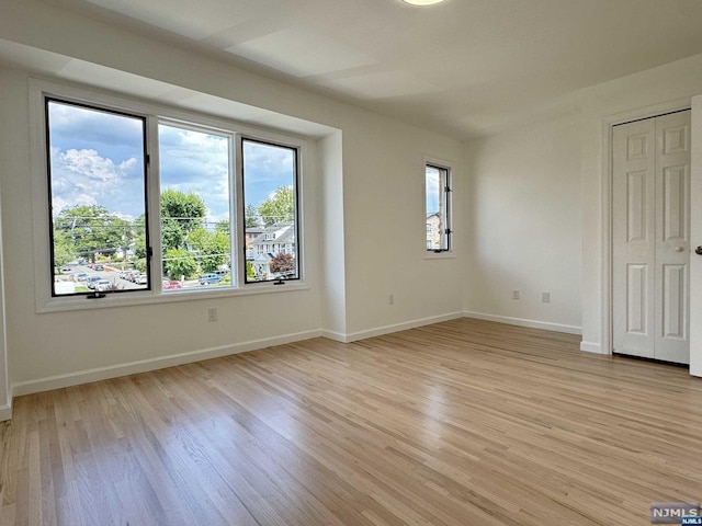 spare room featuring light hardwood / wood-style floors