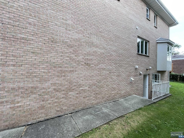 view of side of home featuring a lawn