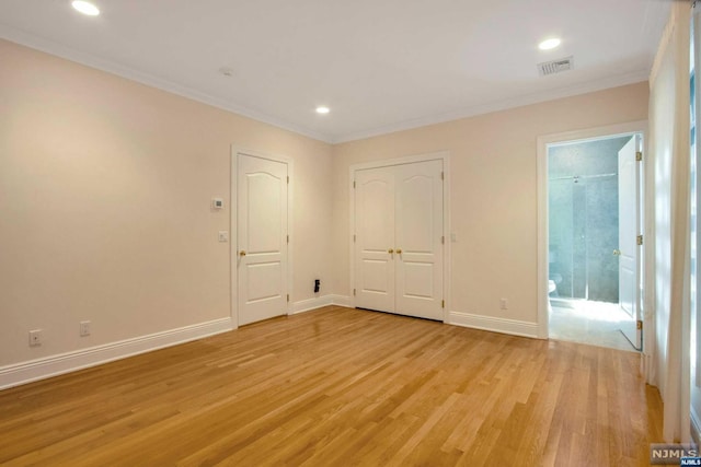 unfurnished bedroom featuring light hardwood / wood-style flooring and ornamental molding