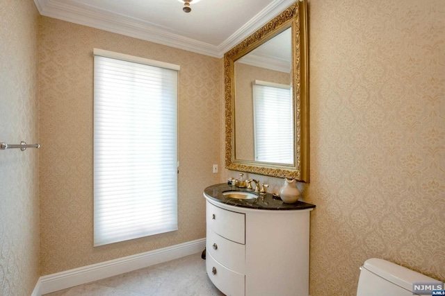 bathroom featuring vanity, toilet, and ornamental molding