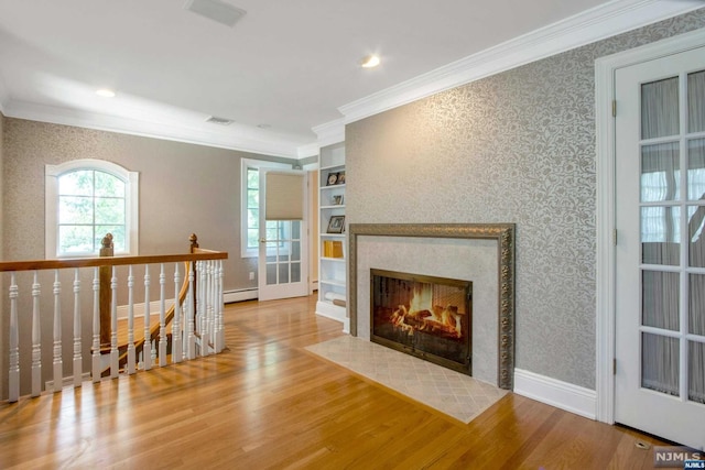 living room with a tile fireplace, light hardwood / wood-style floors, a baseboard heating unit, and ornamental molding