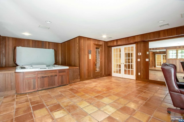 kitchen with french doors and wood walls