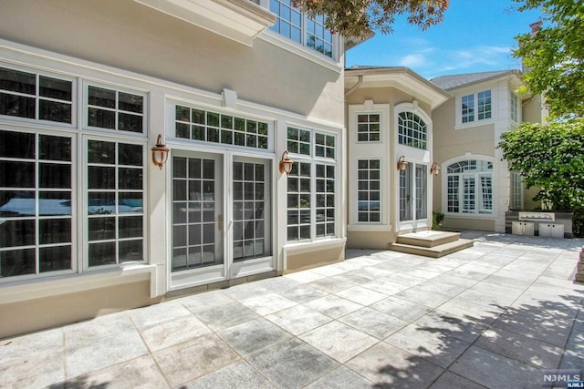 rear view of house featuring french doors and a patio area