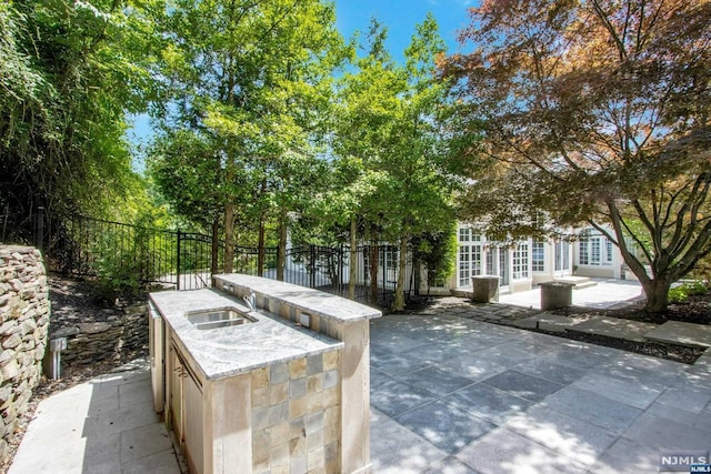 view of patio / terrace featuring french doors and sink