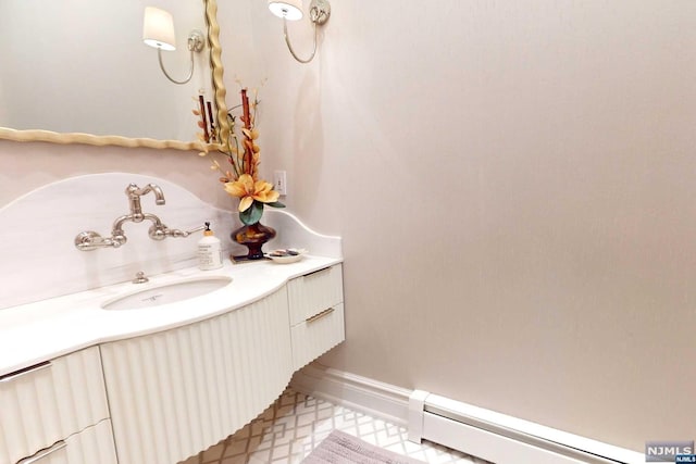 bathroom with vanity and a baseboard heating unit