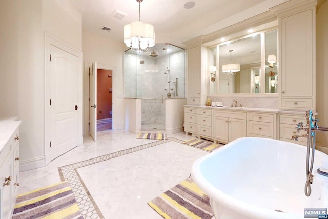 bathroom with shower with separate bathtub, vanity, and an inviting chandelier