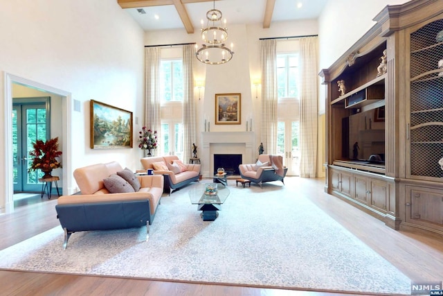 living room featuring beam ceiling and plenty of natural light